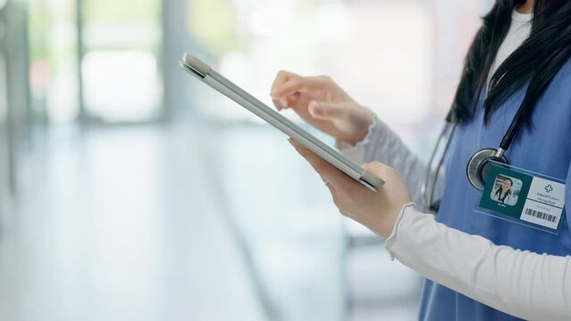 Hands, doctor and typing on a tablet at a hospital for an surgery schedule or healthcare communication. Contact, email or closeup of a nurse with technology at a clinic for medical service or nursing