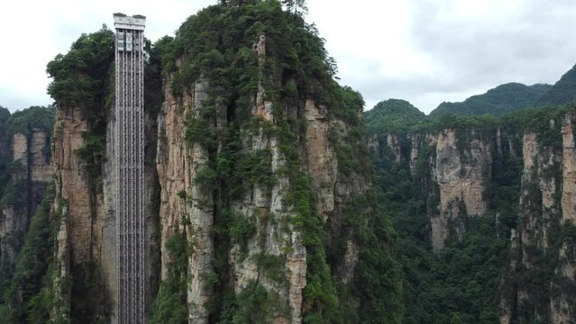 Bailong Elevator In Zhangjiajie National Park; 4K Ascending Drone Parallax Revealing The Height And Depth Of The Tallest Elevator In The World.