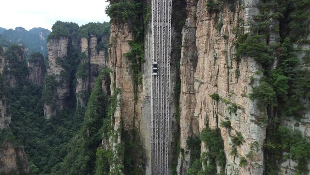China's Bailong Elevator in Zhangjiajie National Park Is The Highest Outdoor Elevator In The World. 4K Aerial Zoom In Shot.