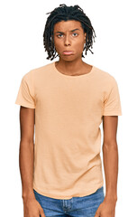 Fototapeta premium Young african american man wearing casual clothes depressed and worry for distress, crying angry and afraid. sad expression.