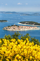 Primosten town on a peninsula vacation in the Mediterranean Sea portrait format in Primošten, Croatia