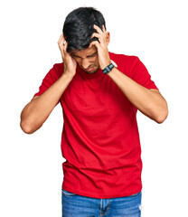 Young handsome man wearing casual red tshirt suffering from headache desperate and stressed because...