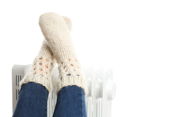PNG,female legs in knitted socks on electric heater, isolated on white background
