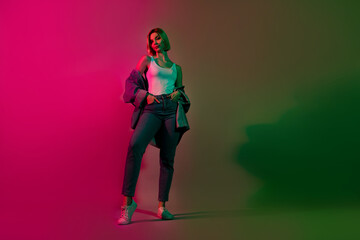 Full body photo of youngster lady standing posing advertise denim clothes garment isolated vibrant neon color background