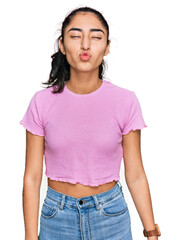 Obraz premium Hispanic teenager girl with dental braces wearing casual clothes looking at the camera blowing a kiss on air being lovely and sexy. love expression.