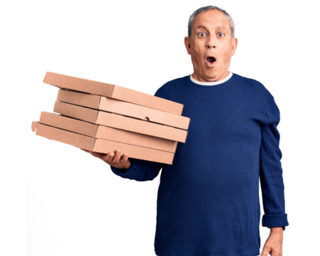 Senior handsome man holding pizza boxes scared and amazed with open mouth for surprise, disbelief face