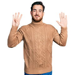 Young hispanic man wearing casual clothes showing and pointing up with fingers number nine while...