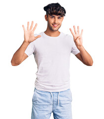 Young hispanic man wearing casual clothes showing and pointing up with fingers number nine while...