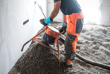 Insulation of the concrete ceiling structure using cast polystyrene. A builder manipulates a...