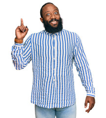 Naklejka premium Young african american man wearing business shirt pointing finger up with successful idea. exited and happy. number one.