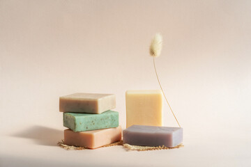 Pattern natural handmade soap of different sizes and colors. Brown background shadows of flowers...