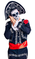 Young man wearing day of the dead costume over background sleeping tired dreaming and posing with hands together while smiling with closed eyes.