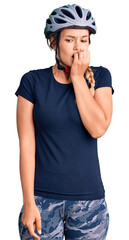 Beautiful caucasian woman wearing bike helmet looking stressed and nervous with hands on mouth biting nails. anxiety problem.
