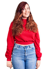 Young beautiful woman wearing casual winter sweater winking looking at the camera with sexy expression, cheerful and happy face.