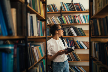 A student stuying and reading books in a public library.