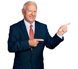 Senior man with grey hair wearing business suit and tie smiling and looking at the camera pointing with two hands and fingers to the side.