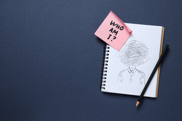 Notepad with pencil drawing and pink note with text on dark blue background, space for text