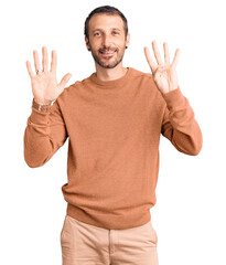 Young handsome man wearing casual clothes showing and pointing up with fingers number nine while smiling confident and happy.