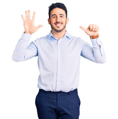 Naklejka premium Young hispanic man wearing business clothes showing and pointing up with fingers number six while smiling confident and happy.
