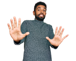 Young african american man wearing casual clothes afraid and terrified with fear expression stop gesture with hands, shouting in shock. panic concept.