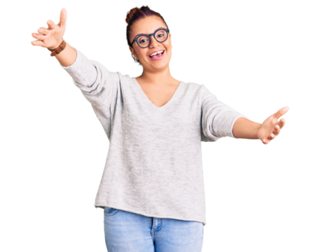 Young latin woman wearing casual clothes looking at the camera smiling with open arms for hug. cheerful expression embracing happiness.