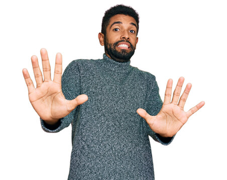 Young african american man wearing casual clothes afraid and terrified with fear expression stop gesture with hands, shouting in shock. panic concept.