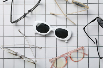 A pair of sunglasses on a checkered black and white background