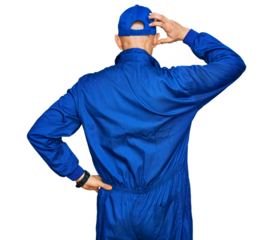 Bald man with beard wearing builder jumpsuit uniform backwards thinking about doubt with hand on head