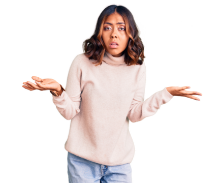 Young beautiful mixed race woman wearing winter turtleneck sweater clueless and confused with open arms, no idea concept.