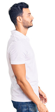 Young handsome hispanic man wearing casual clothes looking to side, relax profile pose with natural face and confident smile.