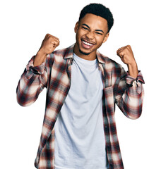 Young african american man wearing casual clothes screaming proud, celebrating victory and success...