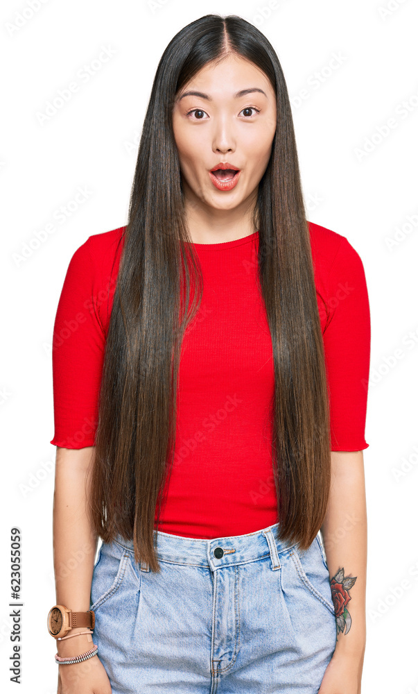 Poster Young chinese woman wearing casual clothes afraid and shocked with surprise expression, fear and excited face.