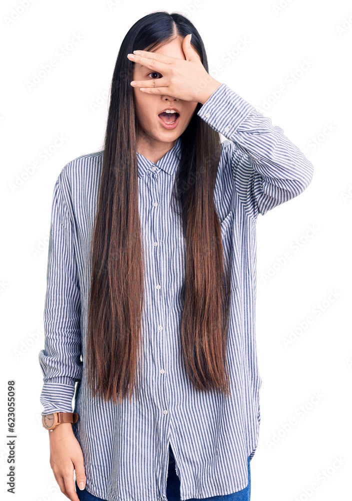 Sticker young beautiful chinese woman wearing casual shirt peeking in shock covering face and eyes with hand