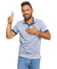 Handsome man with beard wearing casual clothes smiling swearing with hand on chest and fingers up,...