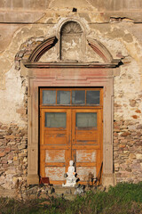 Old wooden door in a baroque portal at the decaying Augustinian monastery building in Pfaffen-Schwabenheim, Germany