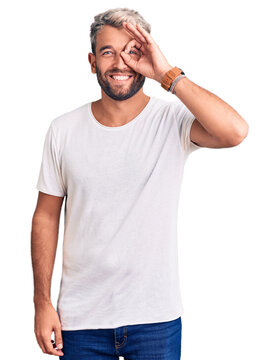 Young handsome blond man wearing casual t-shirt puffing cheeks with funny face. mouth inflated with air, crazy expression.