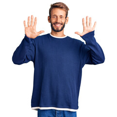 Handsome blond man with beard wearing casual sweater showing and pointing up with fingers number ten while smiling confident and happy.
