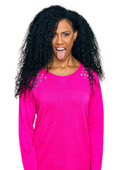 Middle age african american woman wearing casual clothes sticking tongue out happy with funny expression. emotion concept.