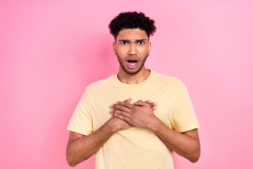 Photo of offended confused upset guy with afro hairstyle dressed yellow t-shirt hold arms on chest...