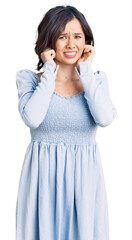 Fototapeta premium Young beautiful girl wearing casual clothes covering ears with fingers with annoyed expression for the noise of loud music. deaf concept.