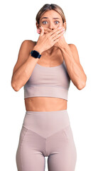 Beautiful caucasian woman wearing sportswear shocked covering mouth with hands for mistake. secret concept.