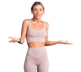 Beautiful caucasian woman wearing sportswear smiling cheerful with open arms as friendly welcome, positive and confident greetings