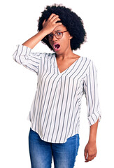Young african american woman wearing casual clothes and glasses surprised with hand on head for mistake, remember error. forgot, bad memory concept.