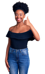 Young african american woman wearing casual clothes smiling happy and positive, thumb up doing excellent and approval sign