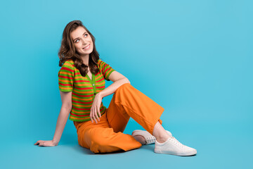 Full length photo of thoughtful minded girl wear striped shirt trousers sit dreamy look at empty...