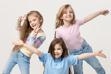 Group portrait of kids girls friends on white studio background. Happy children, cute girls hugging and having fun in carnival glasses. funny faces