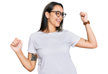 Young hispanic woman wearing casual white t shirt dancing happy and cheerful, smiling moving casual and confident listening to music