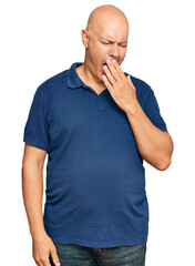 Middle age bald man wearing casual clothes bored yawning tired covering mouth with hand. restless and sleepiness.