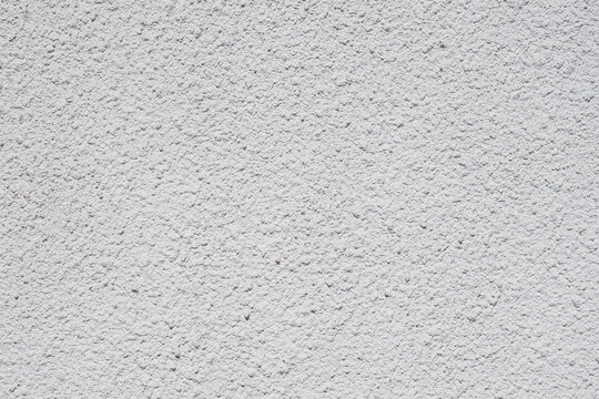 Texture of decorative plaster with a relief. White plaster. Close-up.