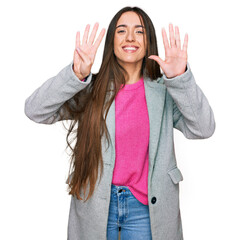 Young hispanic girl wearing business clothes showing and pointing up with fingers number nine while...